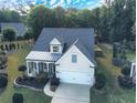 Aerial view of a home showcasing the front yard and tree coverage at 3406 Ravensworth Nw Trce, Kennesaw, GA 30144