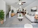 Bright living room with white sofa, striped rug, and open view into the kitchen and dining area at 4001 Avalon Sw Rd, Atlanta, GA 30331