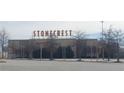 Exterior view of the Stonecrest New Vision movie theater with light colored walls and brown accents at 6004 Spring Way, Stonecrest, GA 30038