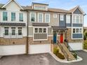 Modern townhome exterior with multiple levels, garage parking, brick accents and colorful doors at 370 Thrasher St # 2, Norcross, GA 30071