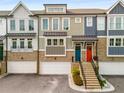 Modern townhome exterior featuring a colorful door and brick accents at 370 Thrasher St # 2, Norcross, GA 30071