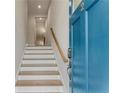 Bright staircase with hardwood steps, blue front door, and white risers at 370 Thrasher St # 2, Norcross, GA 30071