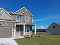 Beautiful two-story home with a lush green lawn and a detached structure in the background at 5994 Spring Way, Stonecrest, GA 30038
