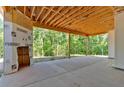 Large, covered patio with exposed wood beam ceiling, offering a serene outdoor living space at 107 Marks Way, Canton, GA 30115