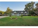 Gray Ranch house with a large yard and mature trees at 79 Russell Ln, Dallas, GA 30157