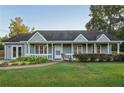 Inviting single-story home with a classic front porch and lush greenery at 79 Russell Ln, Dallas, GA 30157