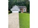 Charming split-level home with well-manicured lawn and two-car garage at 3370 Knighton Rdg, Powder Springs, GA 30127