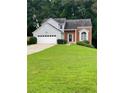 Charming split-level home with well-manicured lawn and two-car garage at 3370 Knighton Rdg, Powder Springs, GA 30127