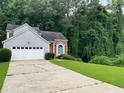 Charming split-level home with well-manicured lawn and two-car garage at 3370 Knighton Rdg, Powder Springs, GA 30127
