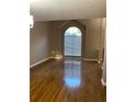 Bright living room featuring gleaming hardwood floors and a large window at 3370 Knighton Rdg, Powder Springs, GA 30127