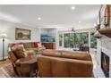 Living room features hardwood floors, leather furniture, and a stone fireplace at 27303 Plantation Ne Dr, Atlanta, GA 30324