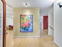 Light-filled entryway with hardwood floors and large floral art at 4599 Park Dr, Pine Lake, GA 30083