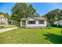 A well-maintained single-story home with fresh landscaping and a paved driveway set on a green lawn at 42 Guinn St, Marietta, GA 30060