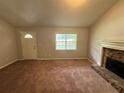 Spacious living room with a stone fireplace and carpeted floors at 194 Spring Leaf Dr, Dallas, GA 30157