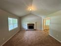 Living Room with vaulted ceiling, fireplace and view into kitchen at 194 Spring Leaf Dr, Dallas, GA 30157