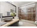 Bathroom featuring a sleek vanity with a vessel sink, and a modern shower over tub with sliding glass doors at 7445 Talbot, Sandy Springs, GA 30328