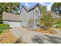 Gray house with attached garage and manicured landscaping at 7445 Talbot, Sandy Springs, GA 30328