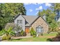 Gray house with stone accents, landscaping, and driveway at 7445 Talbot, Sandy Springs, GA 30328