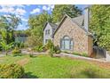 Stone and gray siding house with landscaping and walkway at 7445 Talbot, Sandy Springs, GA 30328