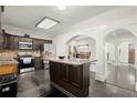 Well-equipped kitchen with stainless steel appliances, granite countertops, a center island and dark wood cabinetry at 7445 Talbot, Sandy Springs, GA 30328