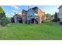 Large backyard with a combination of brick and siding, featuring an elevated deck area at 3450 Camellia Ln, Suwanee, GA 30024
