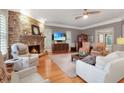 Bright living room with stone fireplace and hardwood floors at 5040 Harrington Rd, Johns Creek, GA 30022