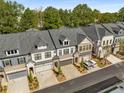 Aerial view of townhomes with manicured lawns, garages, and well-maintained streets at 1070 Harper Dr, Alpharetta, GA 30076
