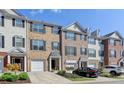 Attractive brick townhome featuring a one-car garage and manicured landscaping in an inviting community at 3676 Chattahoochee Summit Dr, Atlanta, GA 30339