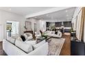 Open-concept living room boasts hardwood floors, comfortable seating, and a seamless flow to the kitchen at 971 Washington Sw Pl, Atlanta, GA 30314
