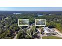 Aerial view showing two cottages near a lake at 5361 N Main St, Acworth, GA 30101