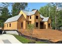 Unfinished home exterior showing the frame, gray roof, framed window openings, and raw sheathing at 440 Allyson Cir, Alpharetta, GA 30009