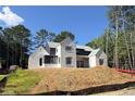 Modern two-story home under construction featuring siding, modern windows, and a partially landscaped lot at 440 Allyson Cir, Alpharetta, GA 30009