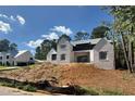 New two-story home construction featuring white brick and dark gray accents, situated on a partially landscaped lot at 440 Allyson Cir, Alpharetta, GA 30009