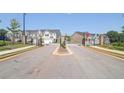 Gated community entrance with landscaping and townhomes visible at 179 Hampton Cir, Mcdonough, GA 30253