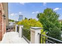 A spacious balcony with black metal railings overlooks lush greenery and cityscape views at 3707 Peachtree Ne Rd # 1, Atlanta, GA 30319