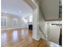 Open-concept living room with hardwood floors, fireplace, and stairs to the basement at 3707 Peachtree Ne Rd # 1, Atlanta, GA 30319