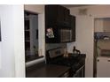 Kitchen featuring dark cabinetry, tile backsplash, and stainless steel appliances at 2697 Vinings Central Dr # 61, Atlanta, GA 30339