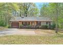 Single-story home featuring neutral siding, a chimney, and a well-kept front yard with trees at 798 Tommy Lee Cook Rd, Palmetto, GA 30268