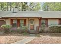Inviting front porch with a lattice railing, charming shutters, and a well-manicured walkway at 798 Tommy Lee Cook Rd, Palmetto, GA 30268