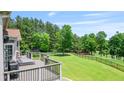 Enjoy the backyard with a lovely deck, lush grass and view of the golf course at 8150 Albritton Downs, Cumming, GA 30041
