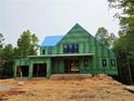 A modern home under construction featuring green weatherboard under a bright blue sky at 170 Cedarwood Ln, Roswell, GA 30075