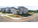 Corner lot home featuring a two car garage, covered entry, sidewalks and a manicured lawn at 1857 Holmsey Cir, Conyers, GA 30094