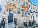 Townhome's front entrance with dark gray door and a wood awning at 4326 Water Elm Aly, Doraville, GA 30360