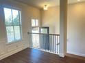 View of upper landing with staircase, hardwood floors, and a window at 4326 Water Elm Aly, Doraville, GA 30360