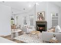 Bright living room with fireplace and hardwood floors at 377 Anders N, Chattahoochee Hills, GA 30268