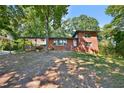 Brick ranch home with a covered carport and nicely landscaped yard at 2953 Collier Nw Dr, Atlanta, GA 30318