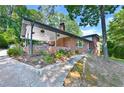 Brick home with carport, landscaping, and walkway leading to the entrance at 2953 Collier Nw Dr, Atlanta, GA 30318