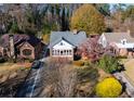 Traditional home with well-maintained lawn, mature trees, and classic architectural details at 1366 Emory Ne Rd, Atlanta, GA 30306