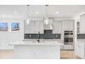 Modern kitchen with gray cabinets, quartz countertops, and stainless steel appliances at 5070 Trescott Path, Cumming, GA 30028