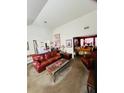 Open living room with a leather sofa and view into another room at 405 Pecan Wood, Fairburn, GA 30213